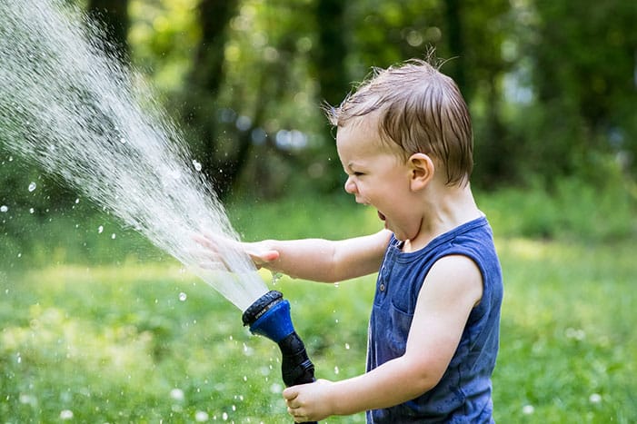 Kid having shower on vacation