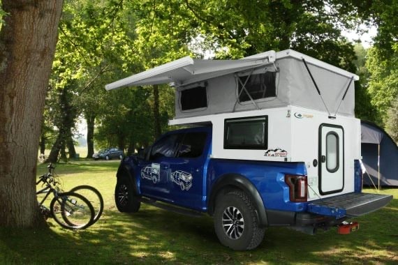 off-road truck bed camper in campsite