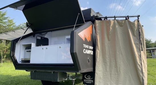Outdoor shower and kitchen in teardrop camper
