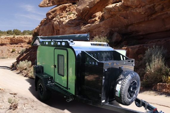 Small Fiberglass Camper in front of rocks