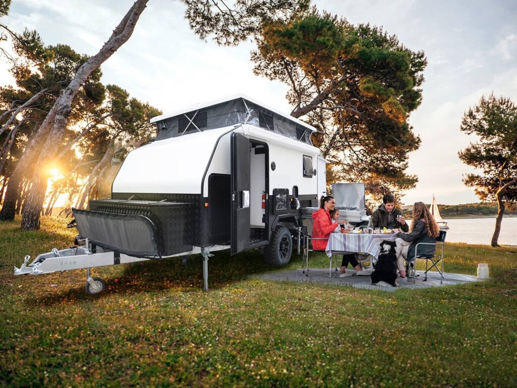 Family camping in small hybrid pop-up camping trailer