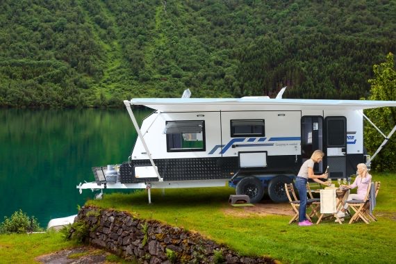 Family camping with awning out in small camper