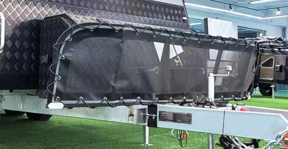Ecocampor caravan chassis and drawbar assembly showing ADR 62 mechanical connection components including safety chain and coupling